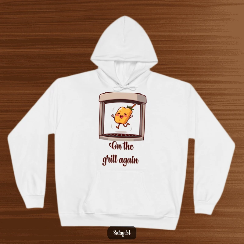 Funny hoodie depicting a happy satay skewer mid-hop on a grill, radiating warmth and playful grilling energy.